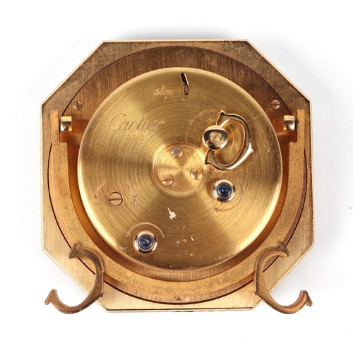 463 - A Cartier gilt metal and black enamel table alarm clock, the white dial with Roman numerals, number ... 