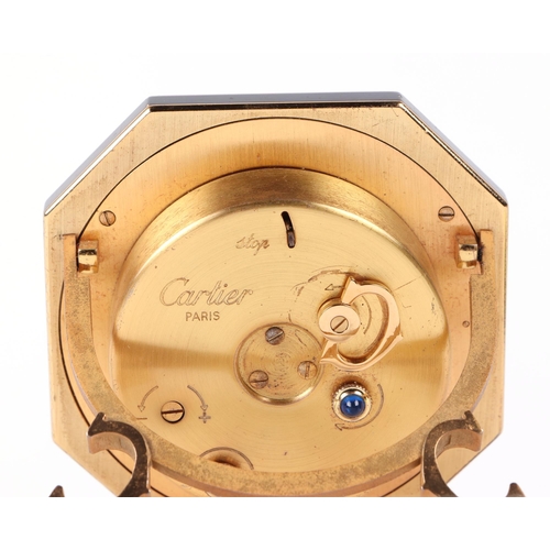 463 - A Cartier gilt metal and black enamel table alarm clock, the white dial with Roman numerals, number ... 