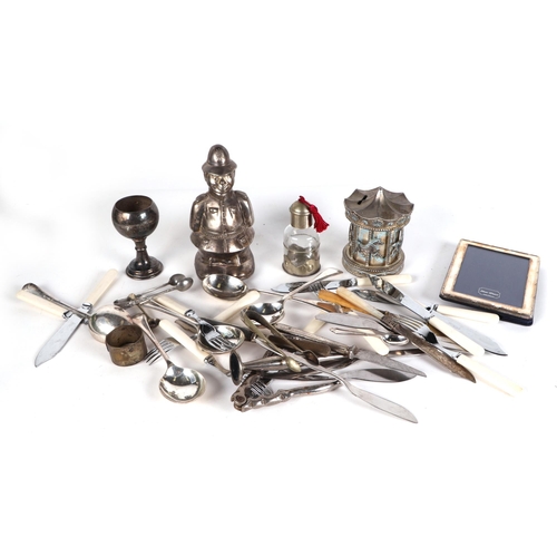 475 - A quantity of silver plated items, including trophy cups, tankers, entrée dishes and other items.