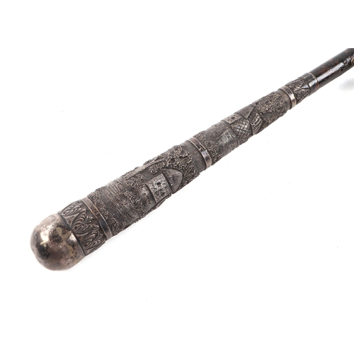 480 - An early 20th century umbrella with Burmese white metal handle, 95cm long.