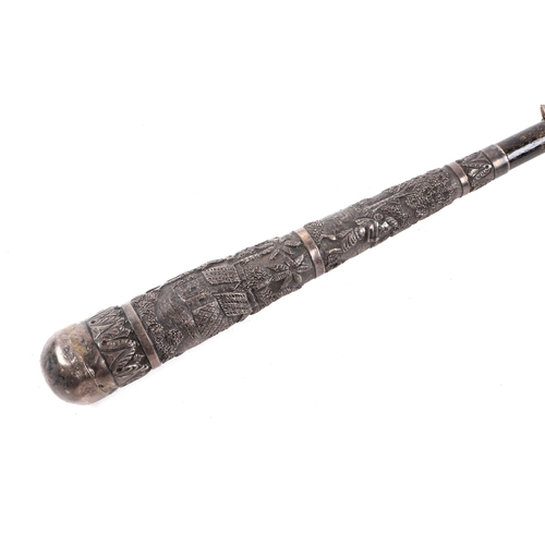 480 - An early 20th century umbrella with Burmese white metal handle, 95cm long.