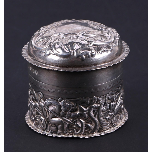 494 - A Victorian silver box and cover of cylindrical form, decorated a cherub and foliate scrolls. London... 