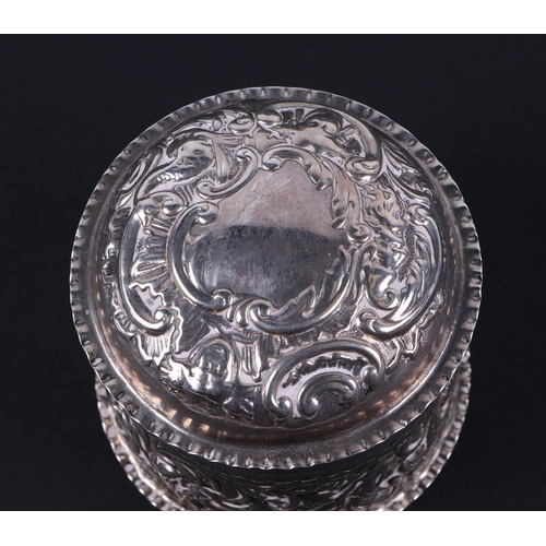 494 - A Victorian silver box and cover of cylindrical form, decorated a cherub and foliate scrolls. London... 