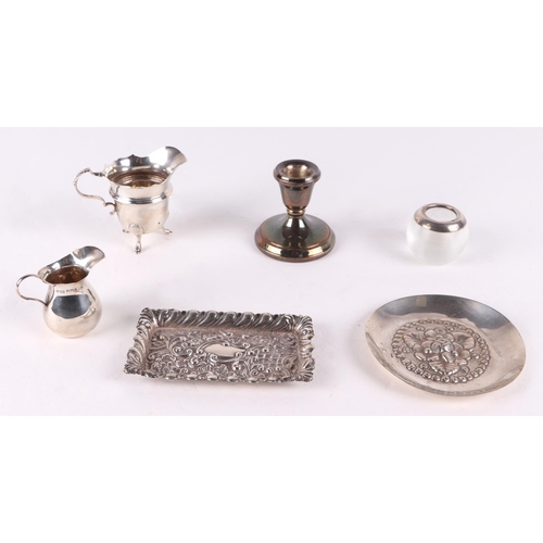 498 - Assorted silver items including a milk jug, pin tray, dwarf candle stick, and a match strike. Variou... 