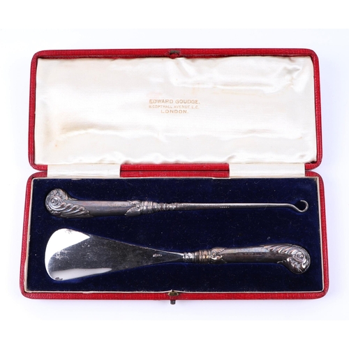 506 - A boxed silver handled shoe horn and button hook set, together with a group of silver handled button... 