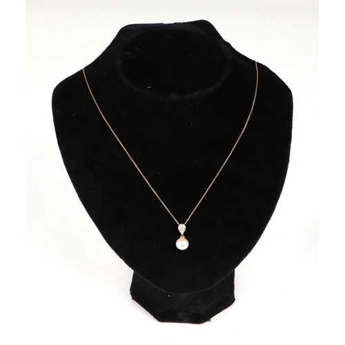 517 - A 9ct gold cultured pearl and diamond pendant, on a fine chain.