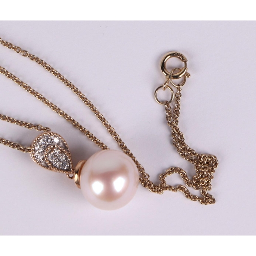 517 - A 9ct gold cultured pearl and diamond pendant, on a fine chain.