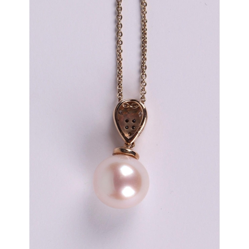 517 - A 9ct gold cultured pearl and diamond pendant, on a fine chain.