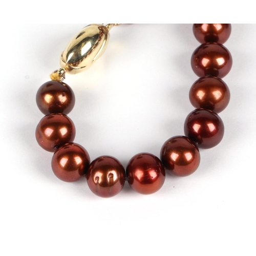 518 - A fresh water cultured chocolate pearl bead necklace, with 9ct gold coffee bean clasp, 45cm long.