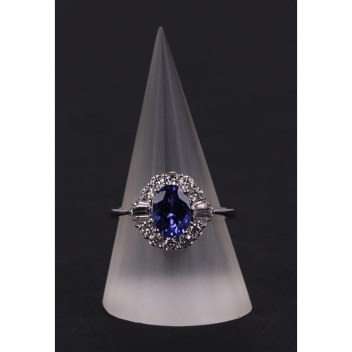 520 - An 18ct white oval tanzanite and diamond cluster ring, tanzanite approx 1.54ct, approx UK size N