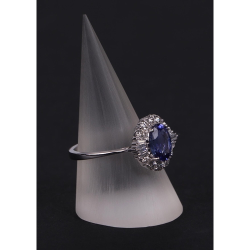 520 - An 18ct white oval tanzanite and diamond cluster ring, tanzanite approx 1.54ct, approx UK size N