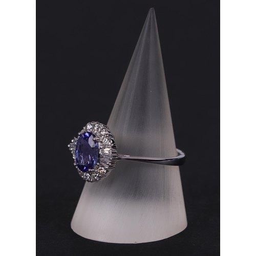 520 - An 18ct white oval tanzanite and diamond cluster ring, tanzanite approx 1.54ct, approx UK size N