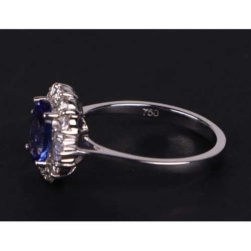 520 - An 18ct white oval tanzanite and diamond cluster ring, tanzanite approx 1.54ct, approx UK size N