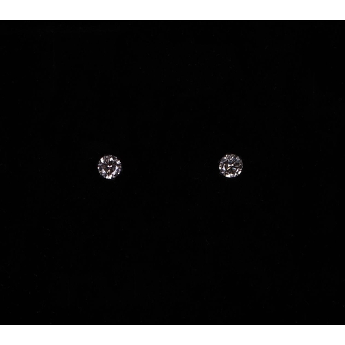 526 - A pair of platinum solitaire diamond stud earrings, diamonds approx 0.20ct.