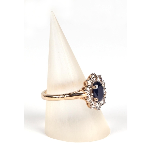 531 - A 9ct gold diamond and sapphire cluster ring, sapphire approx 1.00ct, approx UK size N