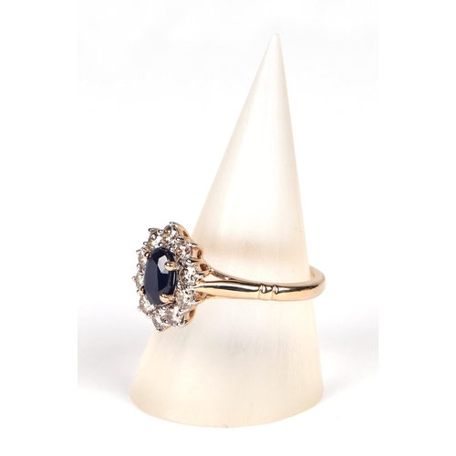 531 - A 9ct gold diamond and sapphire cluster ring, sapphire approx 1.00ct, approx UK size N