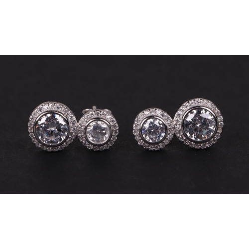 532 - A pair of silver double drop cubic zirconia halo earrings