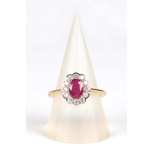 536 - An 18ct white and yellow gold oval ruby and diamond cluster ring, ruby approx 1.02ct, approx UK size... 