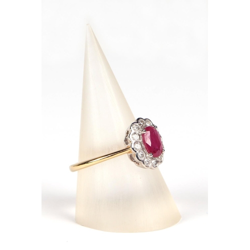 536 - An 18ct white and yellow gold oval ruby and diamond cluster ring, ruby approx 1.02ct, approx UK size... 