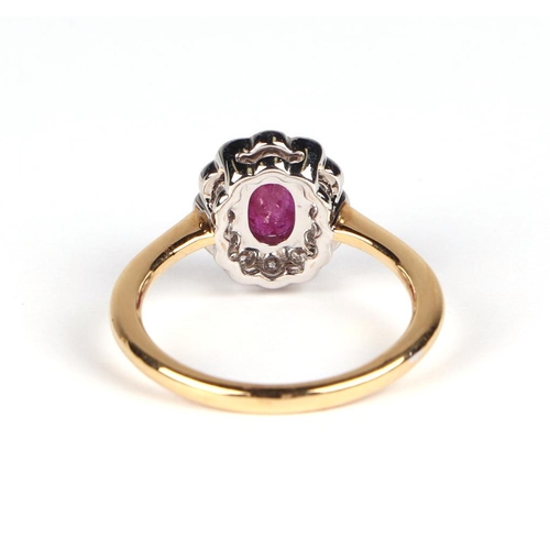 536 - An 18ct white and yellow gold oval ruby and diamond cluster ring, ruby approx 1.02ct, approx UK size... 