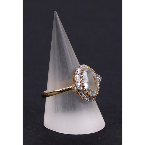 537 - A 14ct gold oval aquamarine and diamond cluster ring, aquamarine approx 2.01ct, approx UK size O.