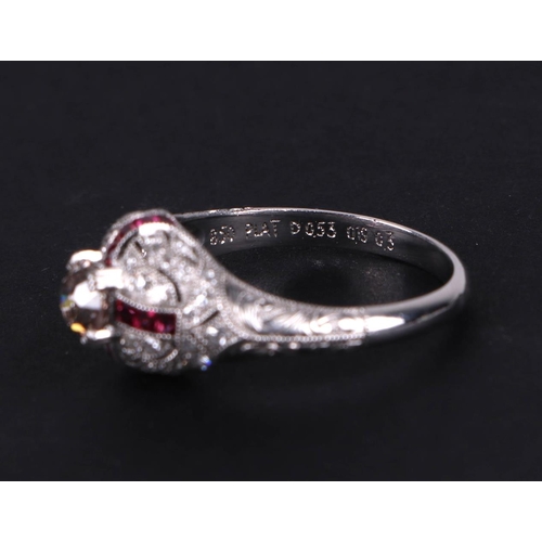 538 - An art deco style platinum ring, set with a central diamond calibre cut rubies and further diamonds,... 