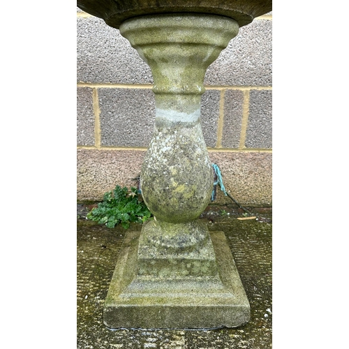 7 - A well weathered stoneware bird bath, 69cm high.