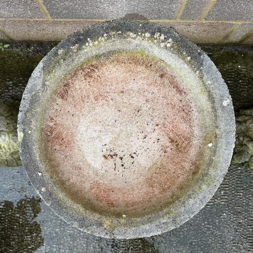 7 - A well weathered stoneware bird bath, 69cm high.