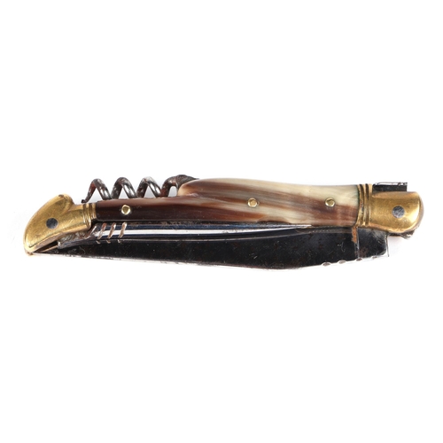 79 - A Laguiole type pocket knife with 9cm blade, corkscrew, pick and horn handle, the blade signed 