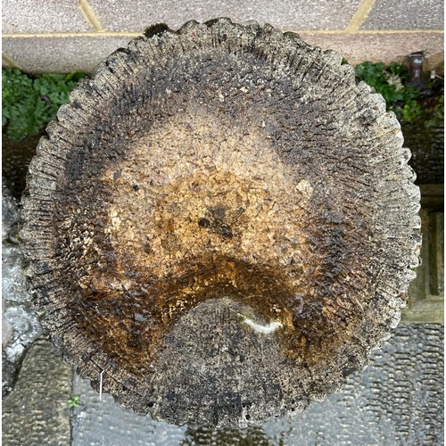 8 - A well weathered stoneware bird bath, 70cm high.