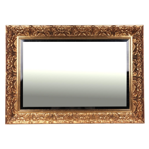 810 - A Victorian style gilt gesso wall mirror with rectangular bevelled plate, 80cm wide; together with a... 