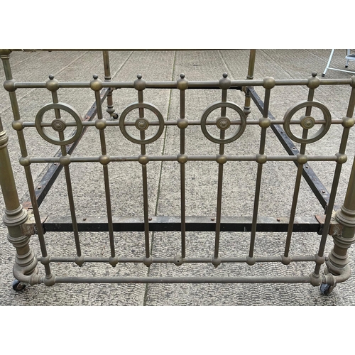 823 - A Victorian brass double bed, 140cm wide.