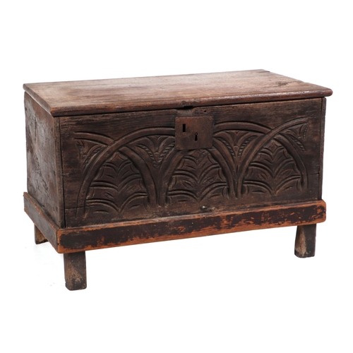 828 - A small oak coffer, with a carved front panel, on a dwarf stile feet, 66cm wide. Condition ReportThe... 