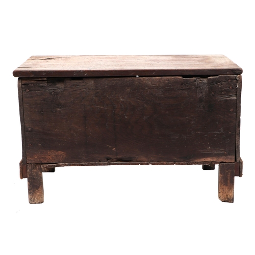 828 - A small oak coffer, with a carved front panel, on a dwarf stile feet, 66cm wide. Condition ReportThe... 