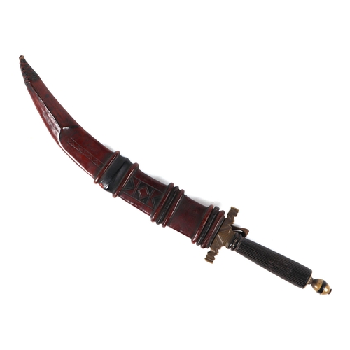 83 - An Arabic/ North Africa jambiya dagger, in tooled leather sheath, 35cm long.