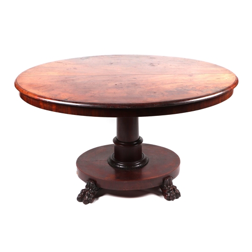 830 - A Victorian mahogany Loo table, the oval top on a turned column terminating in a platform with lion ... 