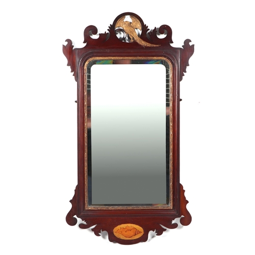 835 - A 19th century mahogany fretwork wall mirror in the George III style, with a ho-ho bird above a beve... 