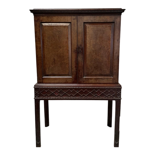 836 - A 19th century mahogany cabinet on stand, the cabinet having twin field panelled doors, opening to r... 