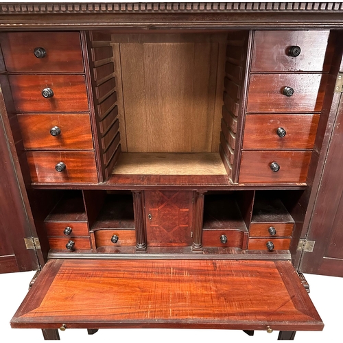 836 - A 19th century mahogany cabinet on stand, the cabinet having twin field panelled doors, opening to r... 