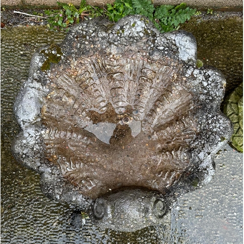 9 - A well weathered stoneware shell form bird bath, 40cm high.