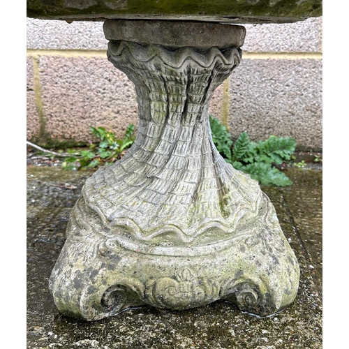 9 - A well weathered stoneware shell form bird bath, 40cm high.