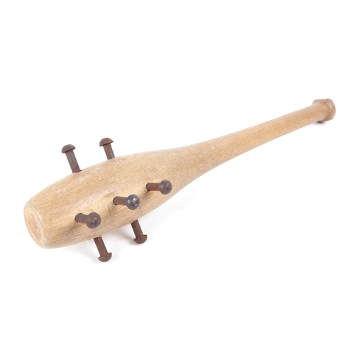 99 - A wooden Trench Club with metal studs protruding from the top. Overall length 36.5cms (14.375ins)