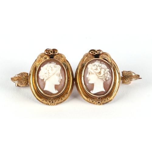 513 - A Victorian yellow metal mounted twin panel cameo brooch, boxed.