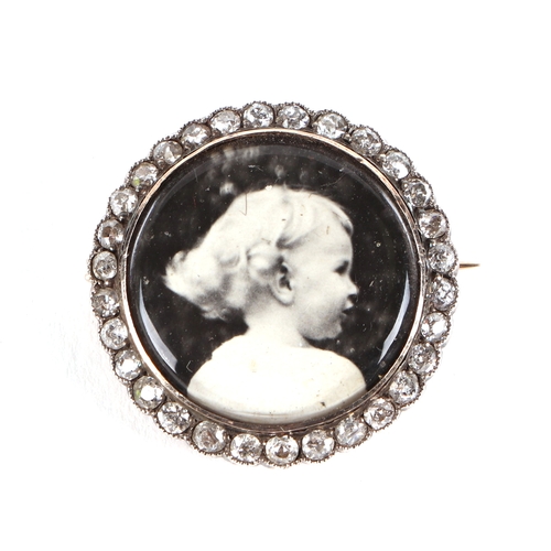 542 - A 19th century yellow metal diamond set mourning brooch, inset a later black and white photograph of... 