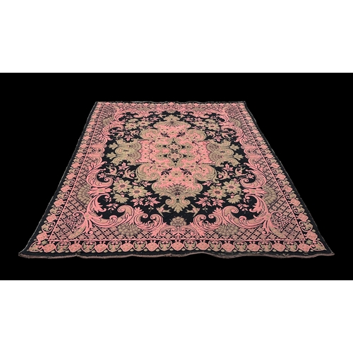 151 - A late 19th / early 20th century needlework wall hanging, the central floral motif on a pink ground,... 