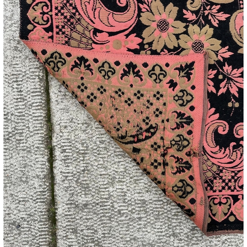 151 - A late 19th / early 20th century needlework wall hanging, the central floral motif on a pink ground,... 