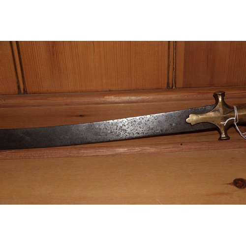 86 - An Indian tulwar sword, with curved steel blade and brass handle, 82cm long.