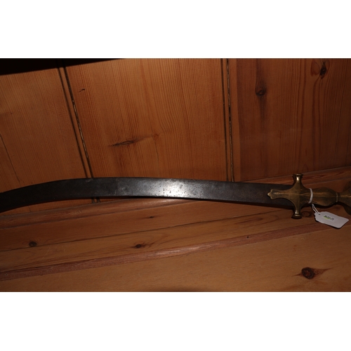 86 - An Indian tulwar sword, with curved steel blade and brass handle, 82cm long.