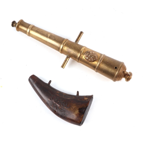 A brass signal cannon, with Royal coat of arms crest, 23long and a 19th ...