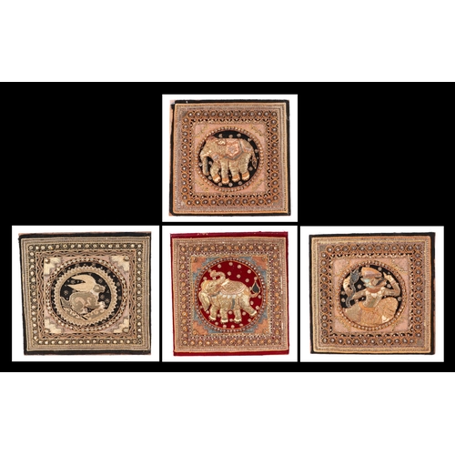 136 - A group of four Indian needlework panels, depicting elephants and mythical creatures, each approx 39... 